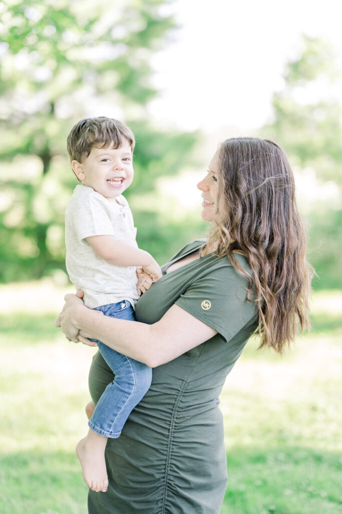 toddler and momma full of joy at maternity session at farmstead of ringoes