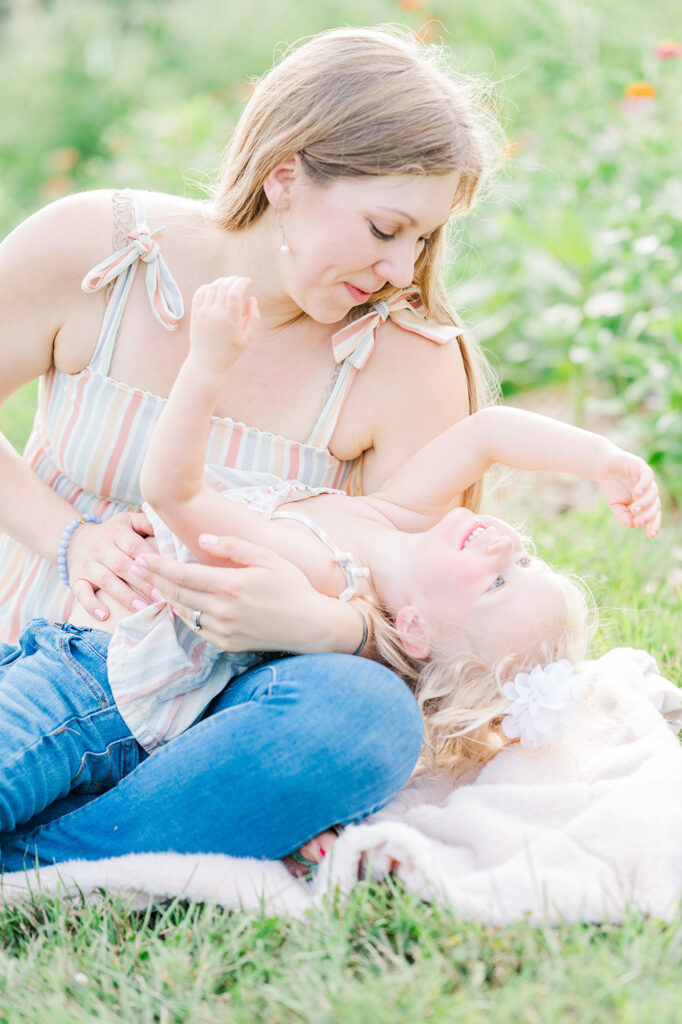 toddler girl laughs as mom tickles her acting silly at Pretty Bird Farm Stockton NJ by Golden Heart Photography Anne Haug Hunterdon County NJ Family Photographer