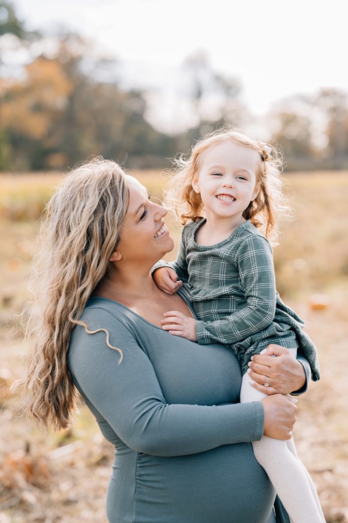 mom and daughter hug and smile at fall mini session with Golden Heart Photography 
