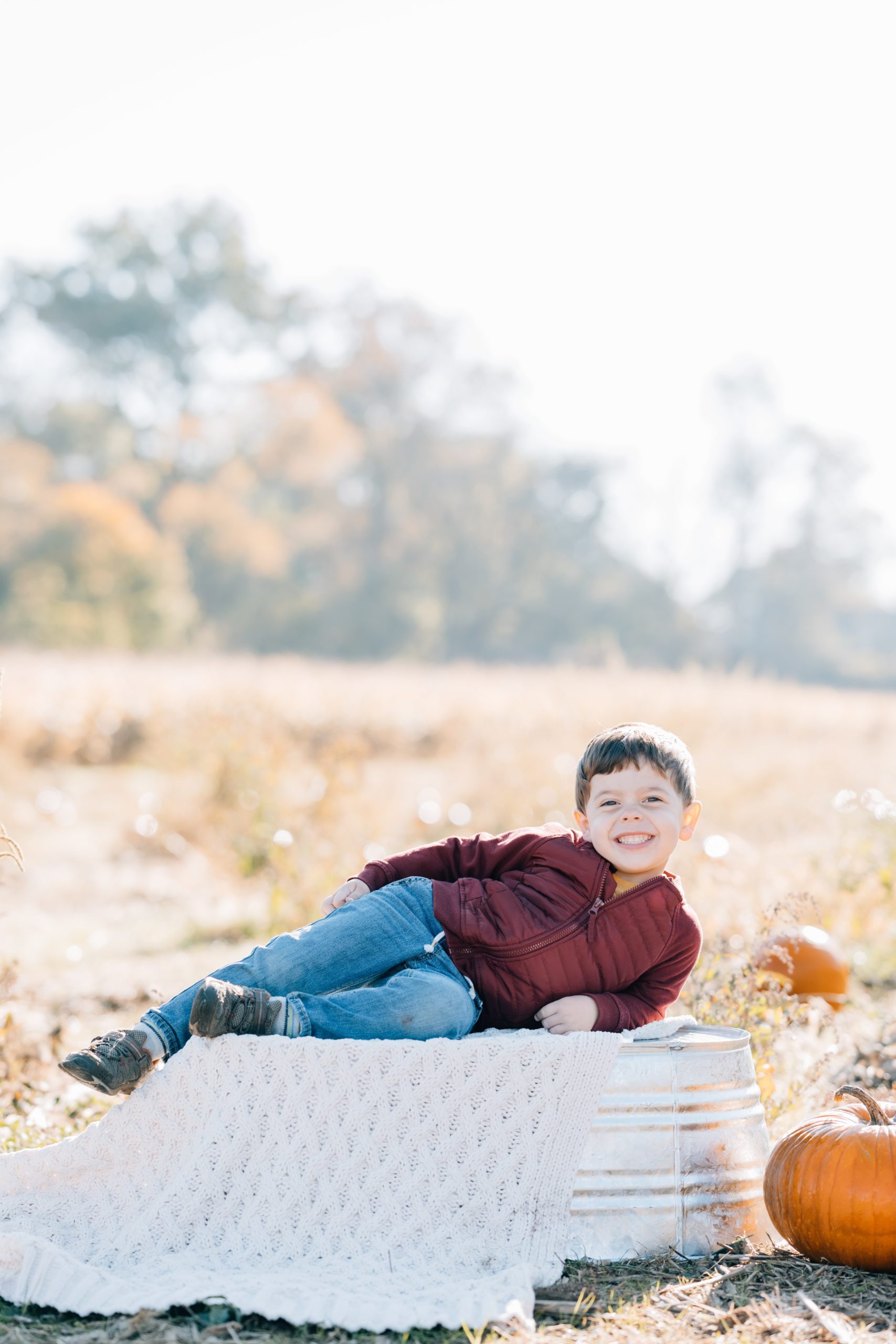 toddler boy poses at fall family session with Golden Heart Photography