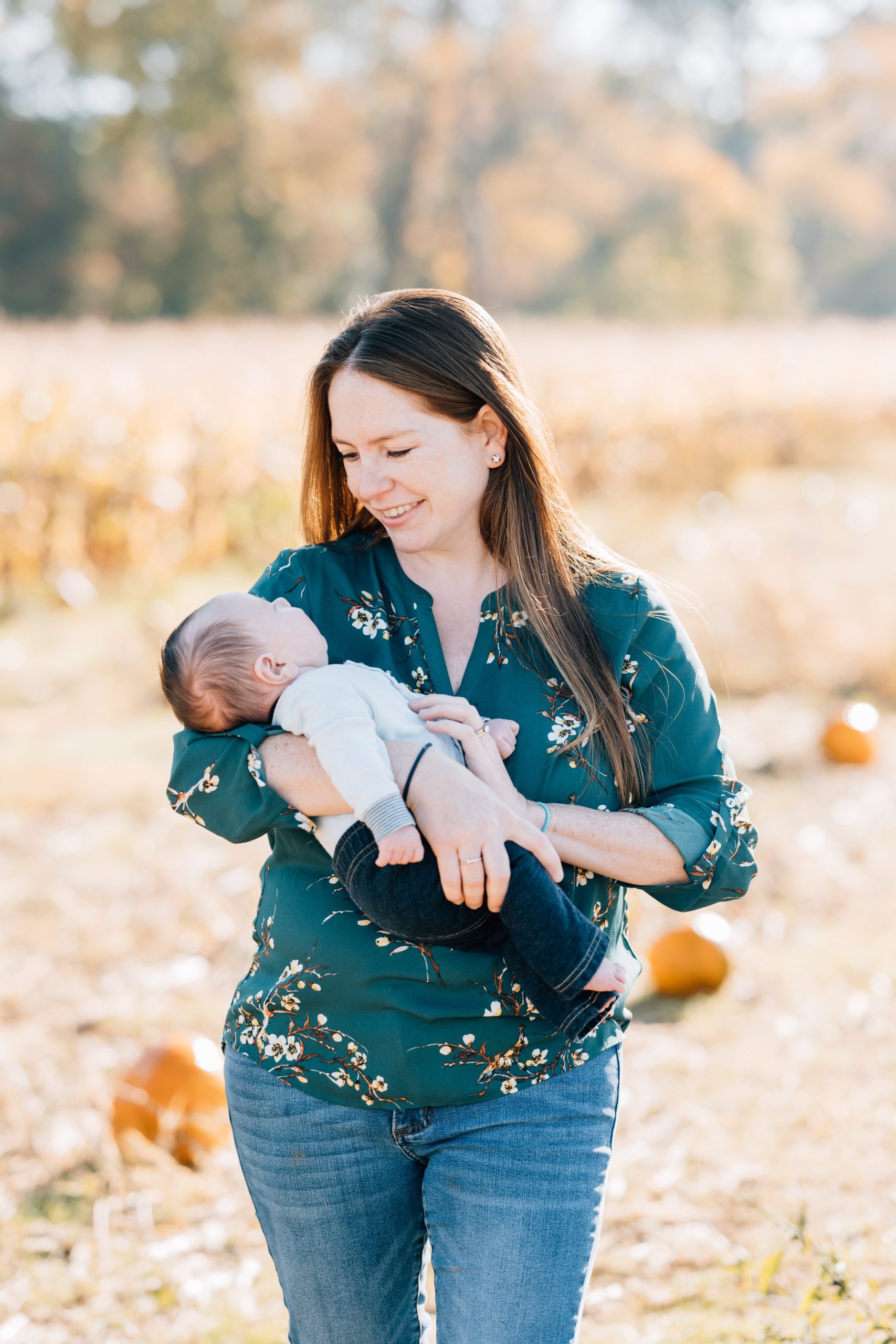 Flemington Fall Lifestyle Newborn Session | Newborn Photography Princeton NJ | The Wellinger Family | Golden Heart Photography mom poses holding newborn baby