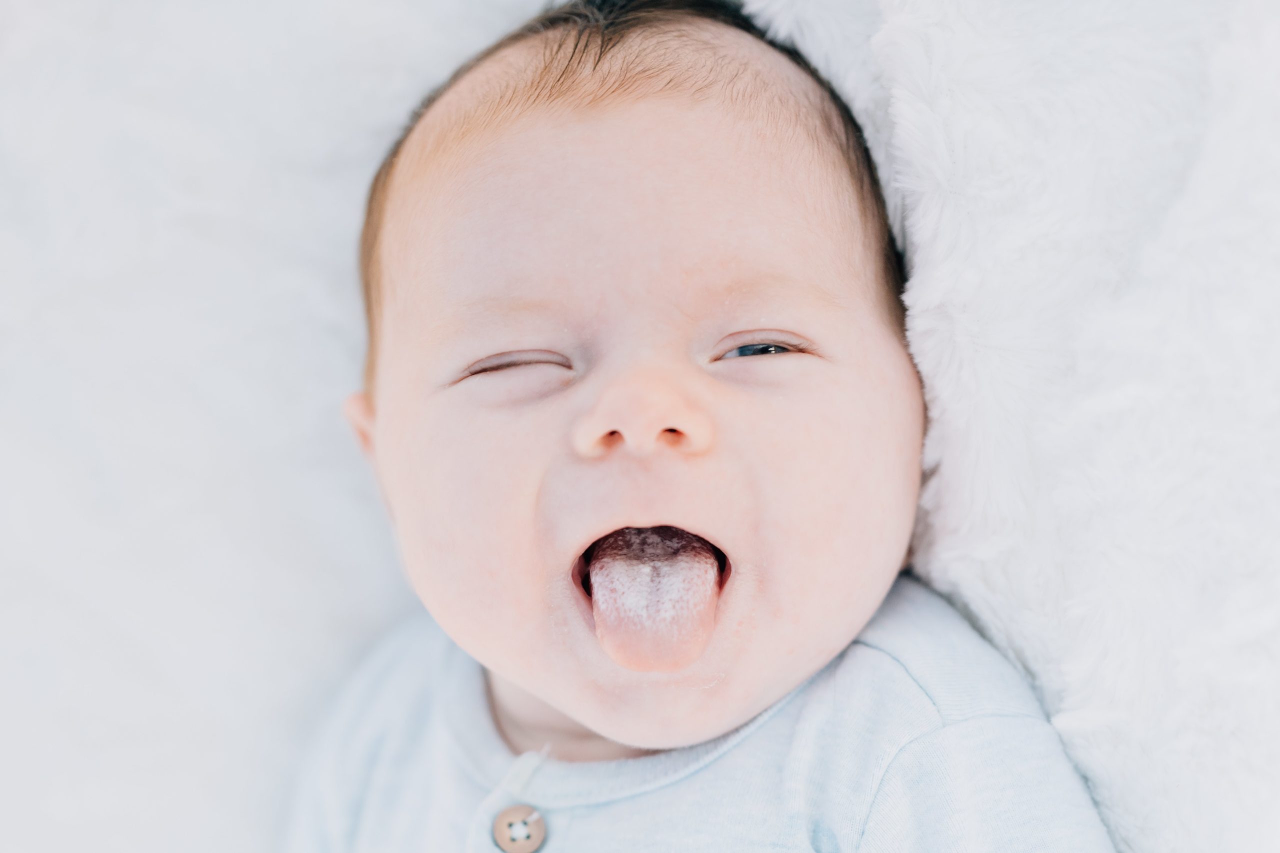 squsihy baby face with tongue sticking out Flemington Fall Lifestyle Newborn Session | Newborn Photography Princeton NJ | The Wellinger Family | Golden Heart Photography