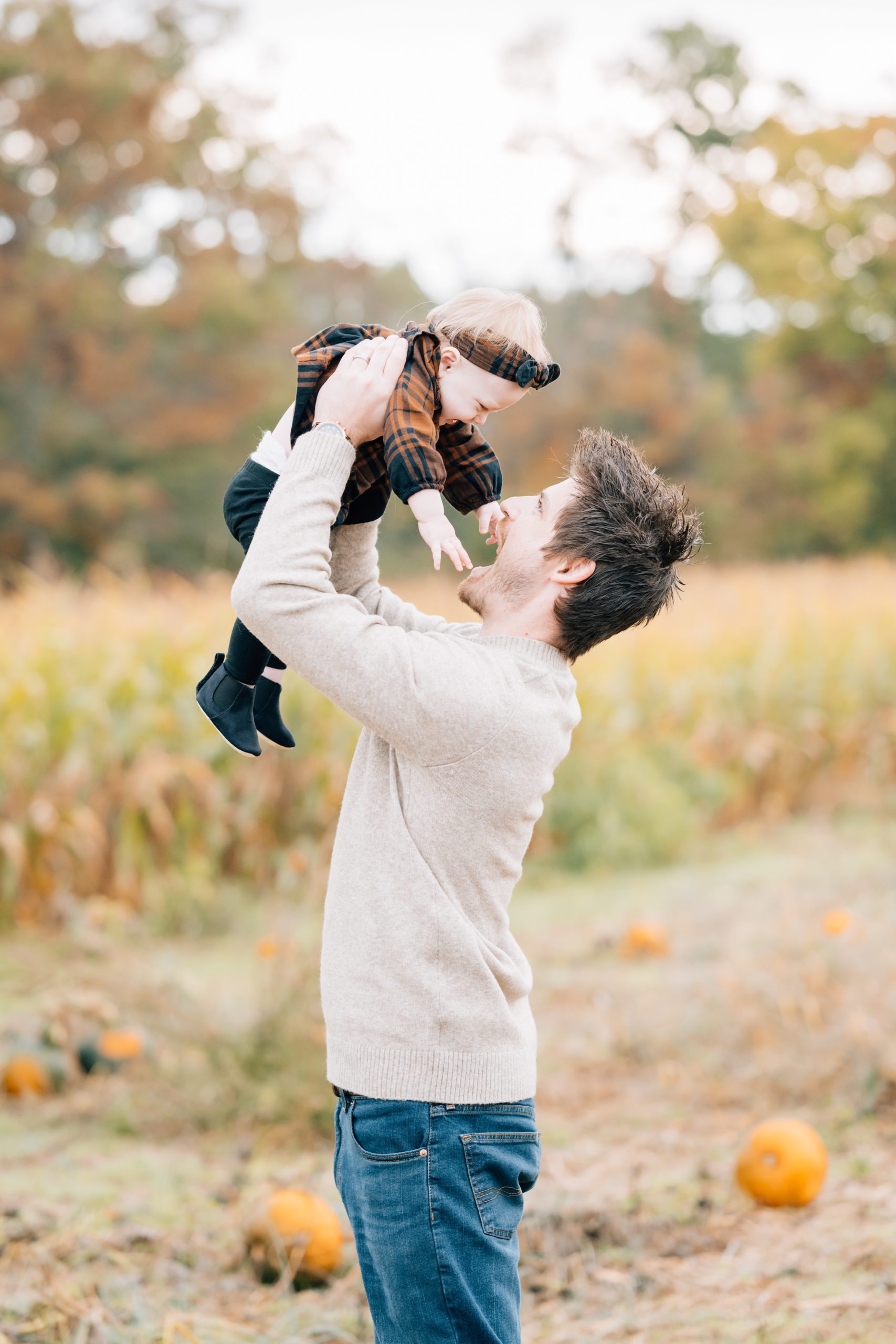 dad poses with baby girl Flemington Fall Mini Session | New Jersey Portrait Photographer | The Newman Family with Golden Heart Photography