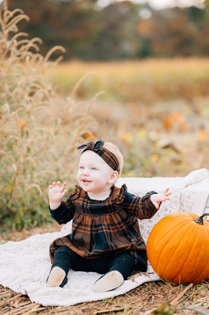 sweet baby girl smiles at Flemington Fall Mini Session | New Jersey Portrait Photographer | The Newman Family with Golden Heart Photography