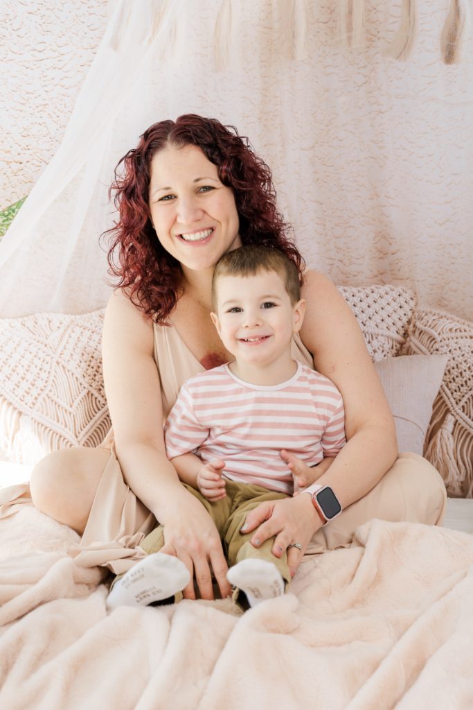 toddler boy poses with mom at Golden Heart Photography session