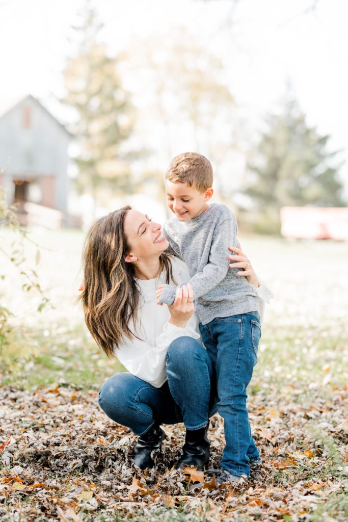 little boy laughs with mom at Golden Heart Photography session