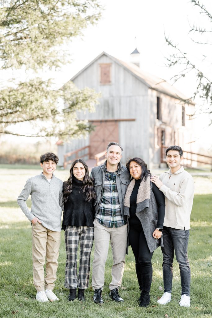 family poses with teen and adult children at session with Golden Heart Photography
