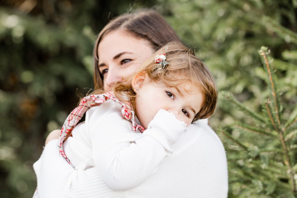 toddler girl finds comfort with her mama at Golden Heart Photography session
