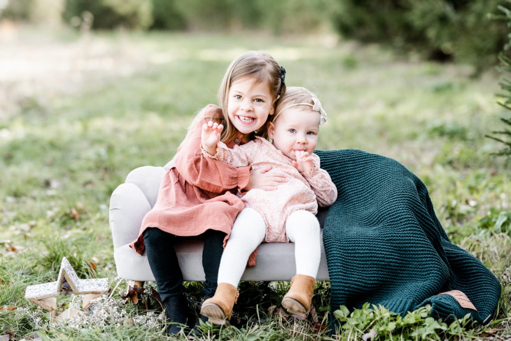 sisters pose on bench Holiday Mini Session | Hunterdon County Mini Sessions | The Furstenburg Family | Golden Heart Photography
