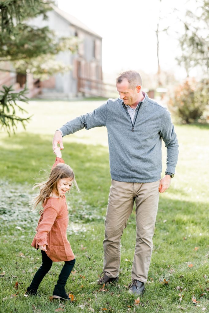 dad twirls toddler daughter to dance Holiday Mini Session | Hunterdon County Mini Sessions | The Furstenburg Family | Golden Heart Photography