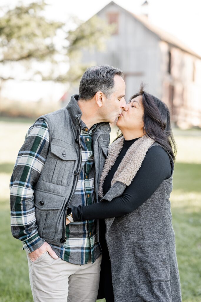 mom and dad share a kiss at session with Golden Heart Photography